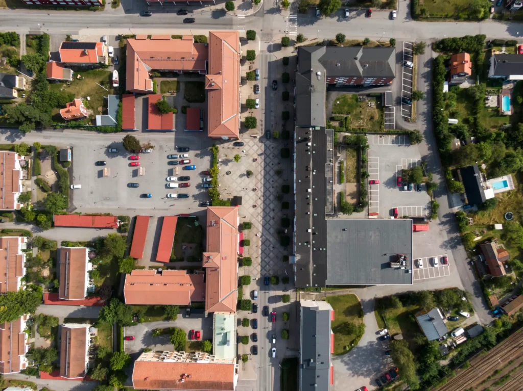 Flyover image of apartment buildings and parking spaces