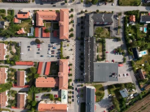 Flyover image of apartment buildings and parking spaces