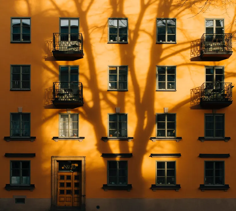A yellow house with windows and balconies
